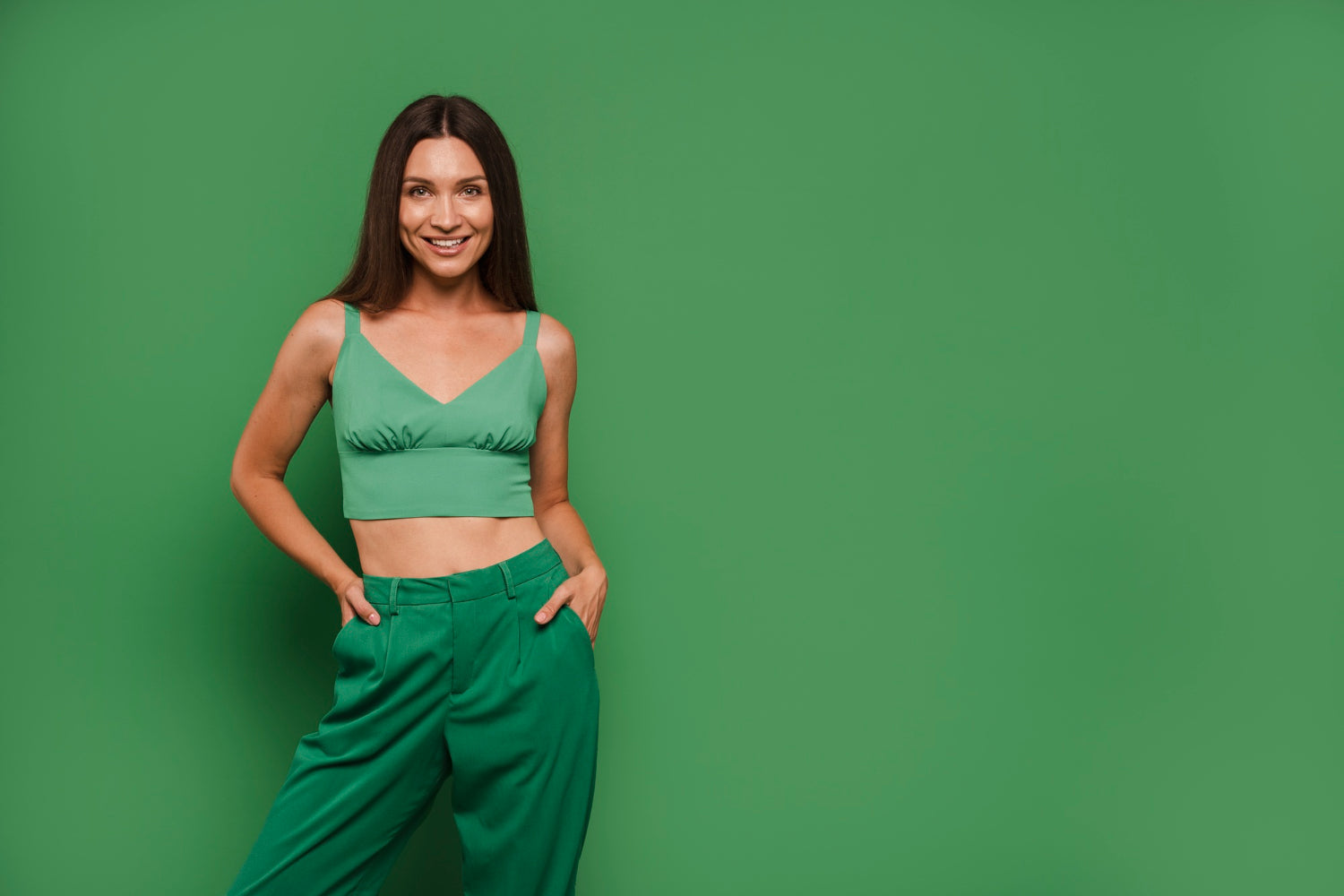 Woman wearing a green outfit against a green background